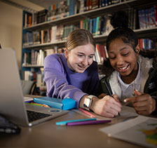 Students in library. Link to Gifts of Real Estate.